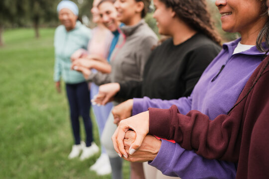 Women's circle during a group yoga class with people of different age and body types - Healthy lifestyle, female connection and meditation concept - Main focus on close up hand