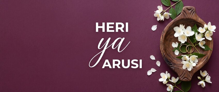 Swahili wedding greeting gold rings with white jasmine flowers flat lay on plum purple background with text Heri Ya Arusi for African marriage congratulation card invitation banner copy space design.