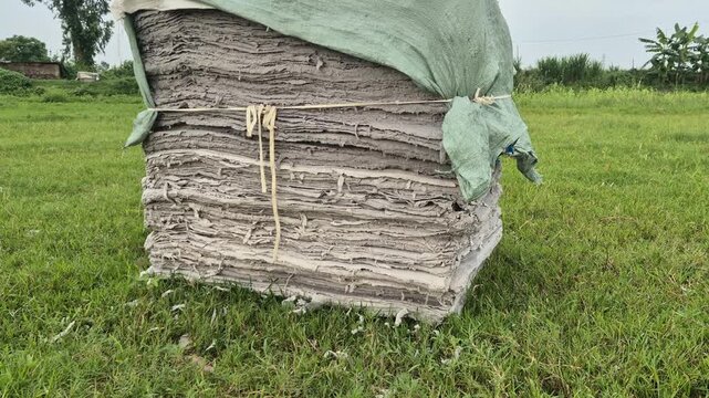 Stack of Recycled Hardboard Sheets Covered with Tarp Outdoor Commercial Video