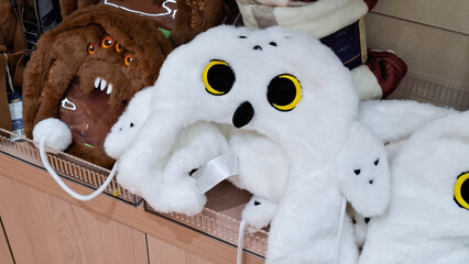 Fototapeta premium Harry Potter Hedwig Miniso snowy owl fluffy winter hat merchandise displayed on retail store shelf on September 16, 2026 in Bangkok, Thailand 