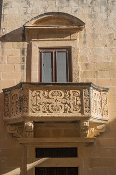 Window and limestone balcony carved with details in the Citadel of Victoria, Gozo MALTA