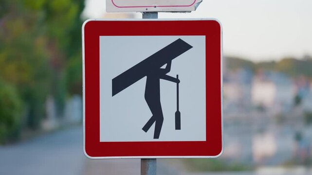Warning sign showing portage route for canoes near dam, riverside road setting