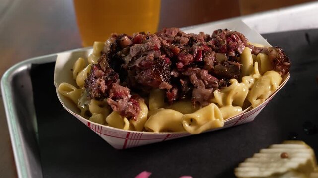 Creamy hatch macaroni and cheese topped with smoky chopped barbecue brisket, close up, slider, 4K