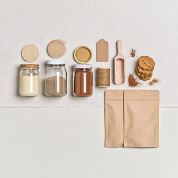 Homemade food and dessert kit with glass jars and shortbread pastries on a cream linen cloth for preserving and packaging layouts