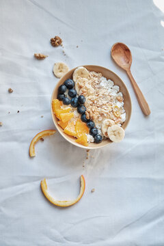 Healthy breakfast with oatmeal cereal, banana, blueberry, orange