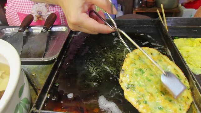 Chinese Egg Pancake known as Ji Dan Bing on street food in Lijiang old town ,Yunnan, China.