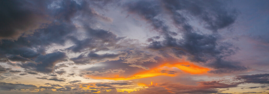 Dramatic clouds paint the sky in twilight hues