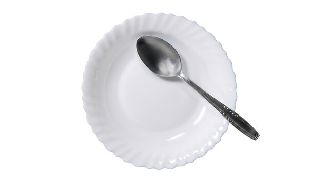 White scalloped plate with silver spoon from above