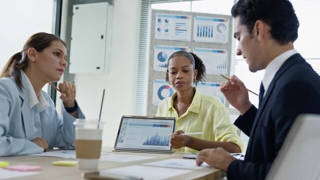 business people meeting and discussion in the office while working on a company project.Business teamwork and team doing corporate research in discussion together with technology in workplace