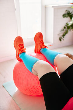 Person exercising with fitness ball at home