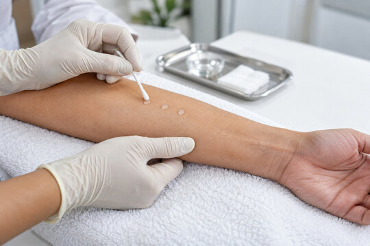 Clinic practitioner performing cosmetic skincare patch test