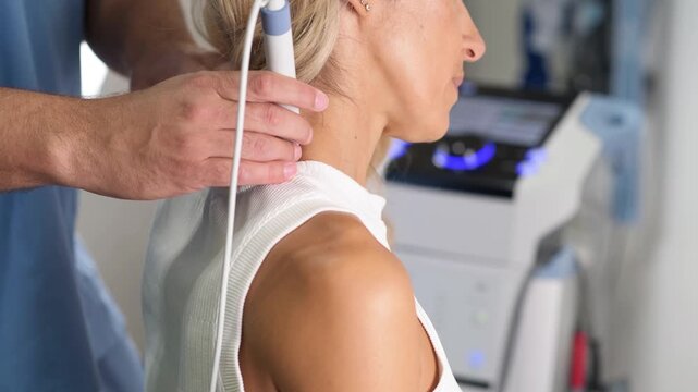 Physical therapist applying therapeutic ultrasound to the shoulder area as part of a professional rehabilitation treatment focused on recovery, mobility, and pain management.