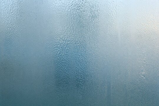 Frosted glass texture with a dimpled semi-transparent surface in soft lavender and periwinkle tones for a clean design background