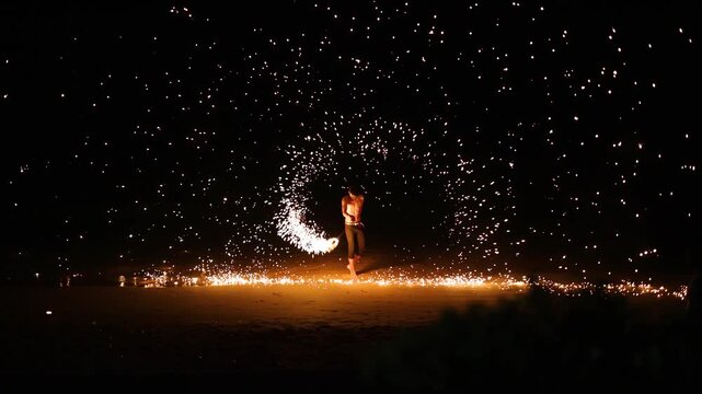 Fireshow on beach in slow motion, night entertainment with fire and sparks, fire dance show with amazing fire sparks.