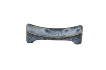Small blue ceramic chopstick rest with a speckled glaze, captured with soft studio lighting on a...