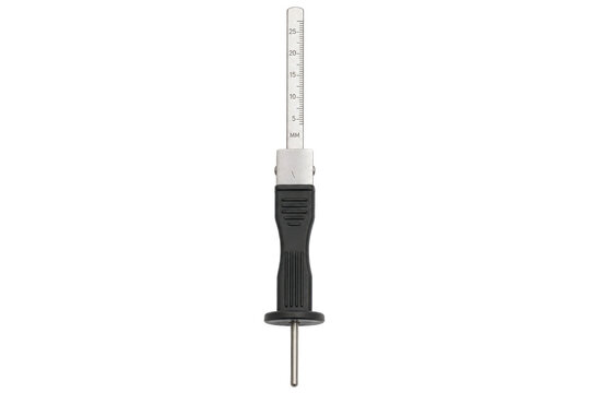 Silver and black tire tread depth gauge with a clear scale, isolated on a clean white background