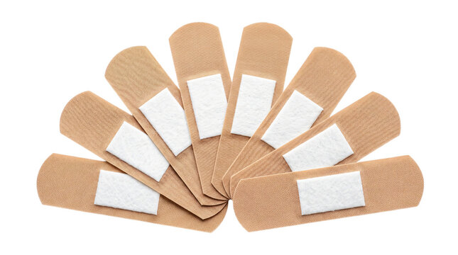 Adhesive bandages arranged in a fan shape. First aid medical supplies on white background
