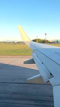 Capturing the Journey: Aerial Perspectives from the Wing of a Plane on a Clear Day Surrounded by Open Skies and Lush Greenery at a Departure or Arrival Point