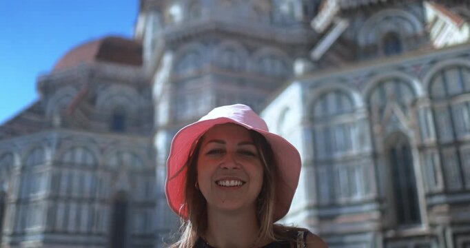 Blond young woman having fun smiling on camera with Florence city in background - Travel, vacation and tourism concept - UGC content
