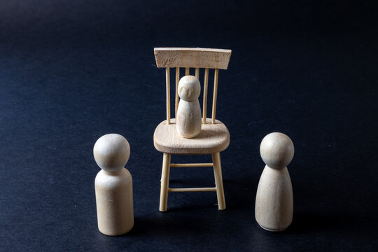 Child Standing On Chair Between Parents