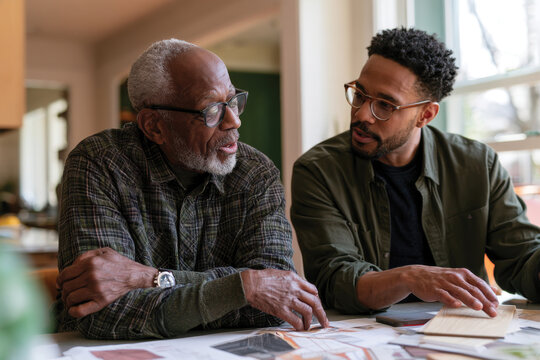 An older man and a younger man engage in a meaningful conversation about creative ideas, illustrating the importance of mentorship and collaboration across generations.