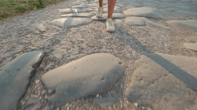 Feet Walking Across Ancient Roman Forum Stones at Sunset