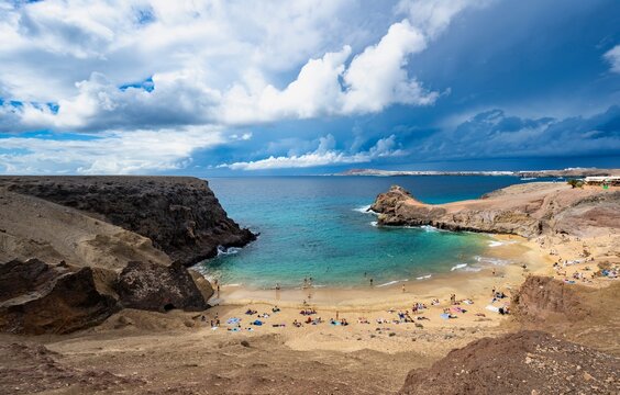 Sandy beach beach and rocky coast with dramatic sky, Playa de Papagayo, coastal landscape, Los Ajaches Natural Park, Lanzarote, Canary Islands, Spain