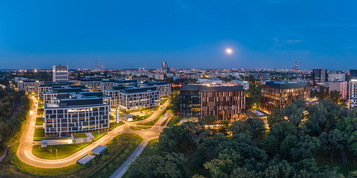 Business Garden offices and Wroclaw skyline under the moon at blue hour, aerial panorama, Poland