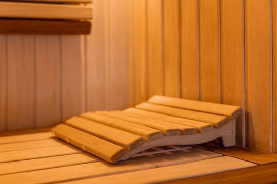 Wooden sauna headrest on bench. Close interior detail for sauna design content.