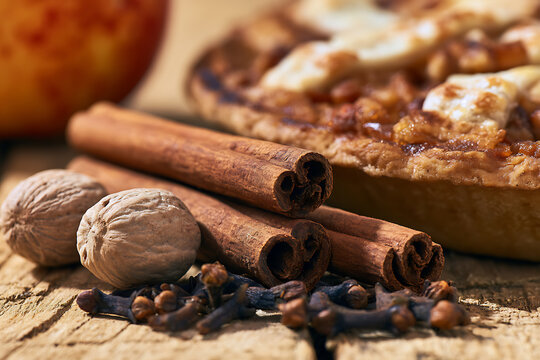 Thanksgiving dessert with spices and apple pie on a wooden table