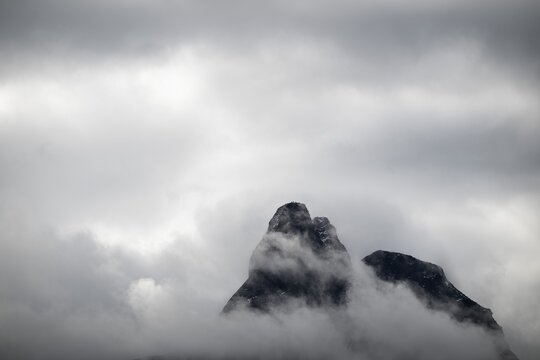 Mountain peak rising from clouds, near &Aring;ndalsnes or Andalsnes, Rauma municipality in M&oslash;re og Romsdal province, Norway