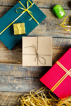Colored gift boxes on wooden background with ribbons