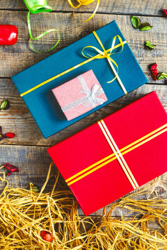 Colored gift boxes on wooden background with ribbons