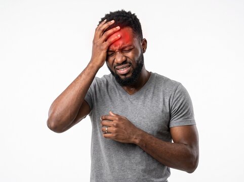 Stressed African American man touching his head suffering from severe headache or concussion symptoms