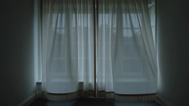 Shifting sheer curtains parting, billowing at multi-pane window from breeze through right casement