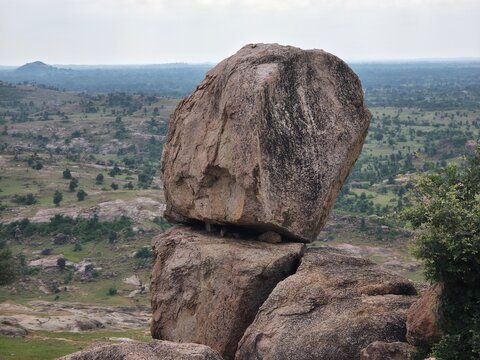 Towering Boulder Over Distant Countryside