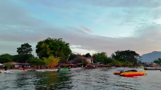 Toba, Indonesia - May 29, 2025: Cinematic aerial view of sunset at Pasir Putih Beach, Balige