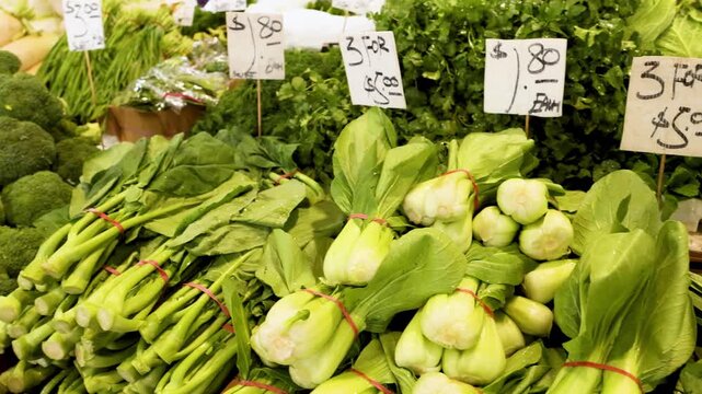 Fresh organic vegetables displayed at an outdoor farmers market produce stall in Australia.