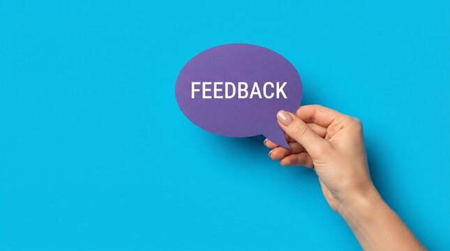 Feedback speech bubble held by hand, purple paper chat icon on blue background, customer review and communication concept