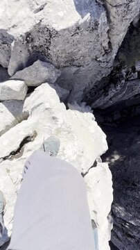 Explorer Crossing Sharp and Unusual Rock Holes in the Wild Mountains