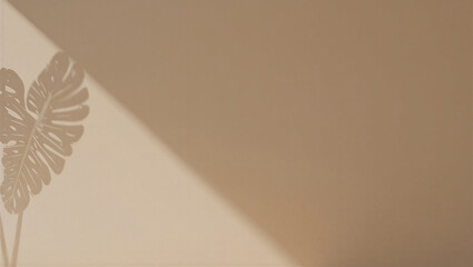 Shadow of tropical monstera leaf on beige wall with dramatic silhouette © Devil Space
