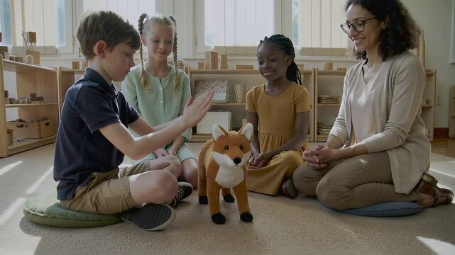 Reaching boy on green cushion patting plush fox during circle time, peers and teacher watching