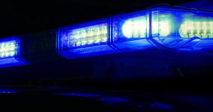 Emergency services flashing lights &ndash; police car at law enforcement crime scene, firefighter on call or light on paramedic ambulance at medical emergency. Night time scene.
