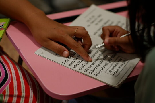 Mother Helping Her Child with Homework and Learning at Home Desk