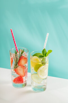 Two fresh non alcoholic drinks with strawberry and lemon on blue background