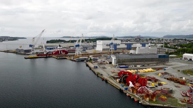 Industrial Worley Rosenberg shipyard facility with cranes and ships in Stavanger, Norway. Aerial drone view