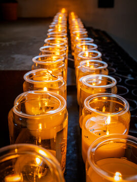 Rows of glowing votive candles creating a warm spiritual atmosphere