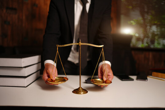 Lawyer Reviewing Documents with Legal Technology Icons and Scales of Justice