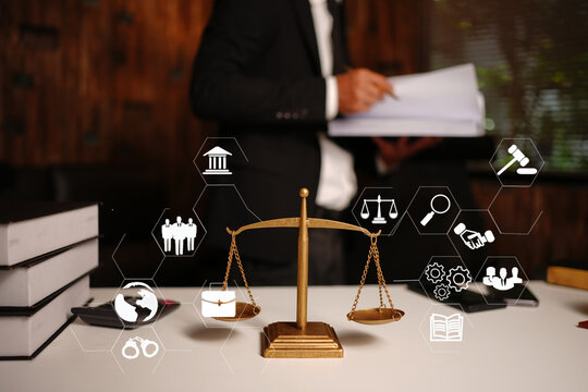 Lawyer Reviewing Documents with Legal Technology Icons and Scales of Justice