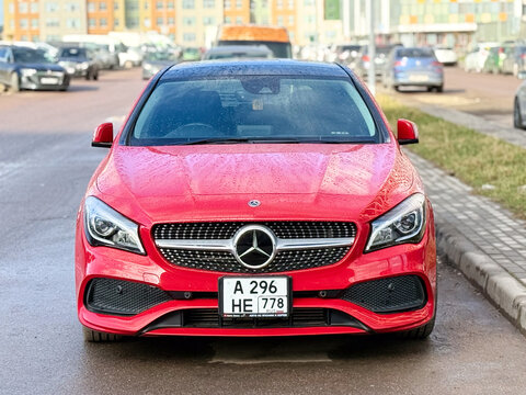 Red Mercedes-Benz CLA Shooting Brake X117 premium compact station wagon car parked outdoors. German FWD automobile vehicle based on MFA platform architecture with a turbo petrol inline-four engine.